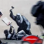 Banksy UK Justice beats protester