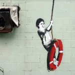 Banksy New Orleans Boy on Life Preserver swing