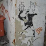 Banksy Berlin throwing flowers