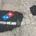 DE Milford advert Dominos pot hole