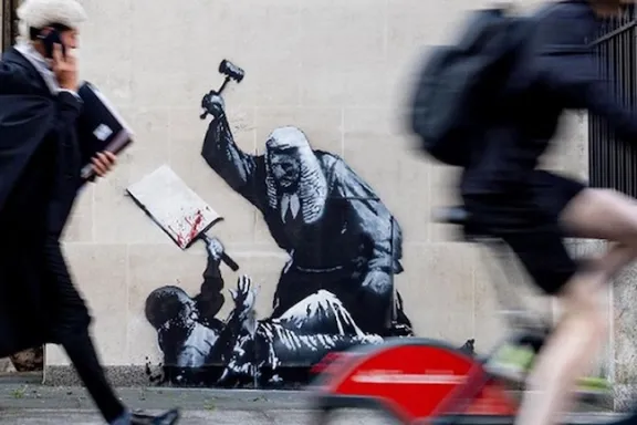 Banksy UK Justice beats protester