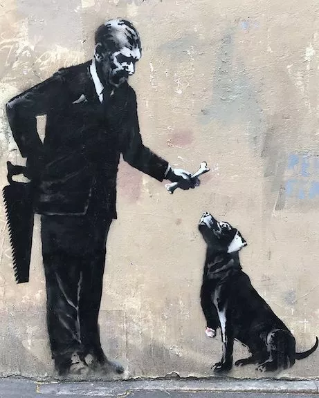 Banksy Paris 2018 giving dog a bone