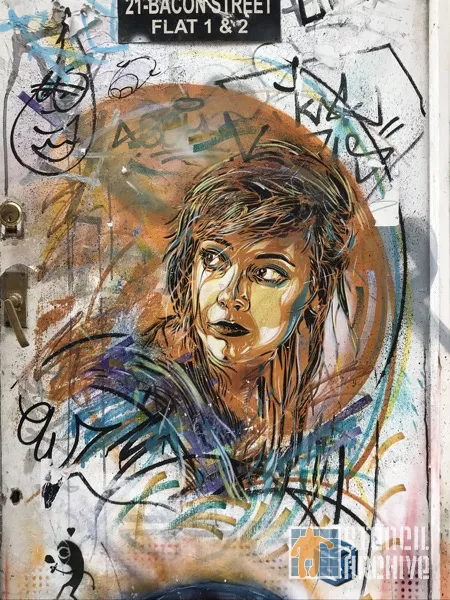 C215 UK London Brick Ln woman looking right
