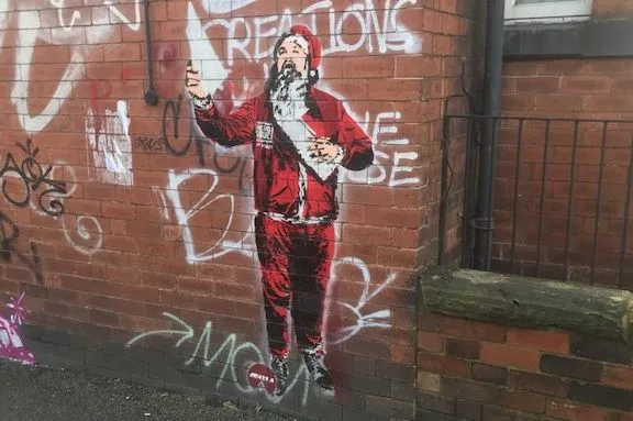 UK Leeds Santa selling papers