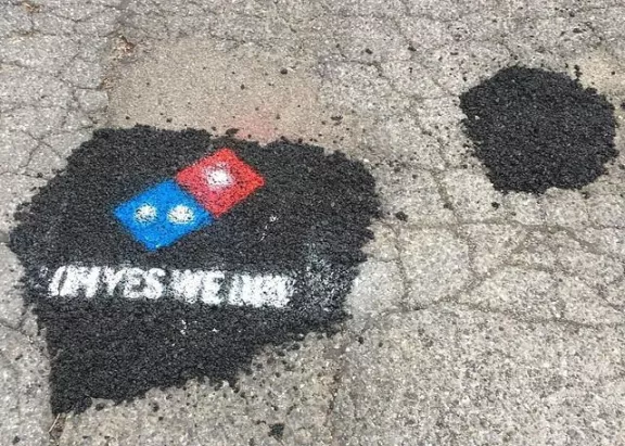 DE Milford advert Dominos pot hole